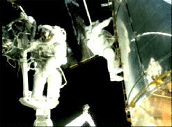 Footage from the HST servicing mission showing the astronauts working in space.