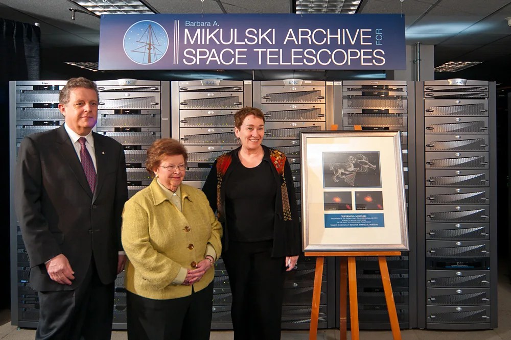 Senator Mikulski is at picture center, STScI Director Matt Mountain at her right, and STScI Deputy Director Kathryn Flanagan at her left