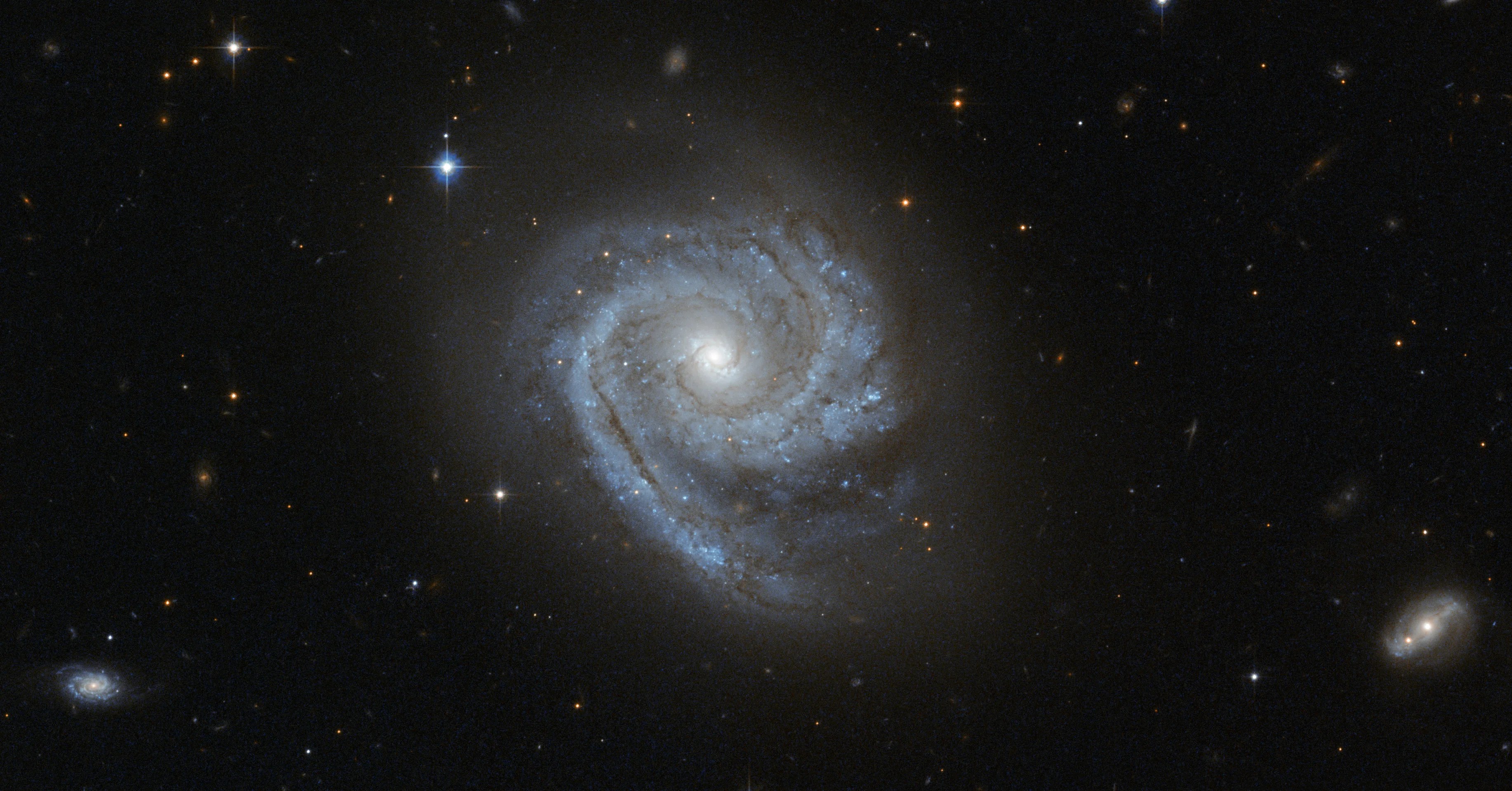 ESO 498-G5's luminous spiral arms with dark filaments wind all the way in to the center