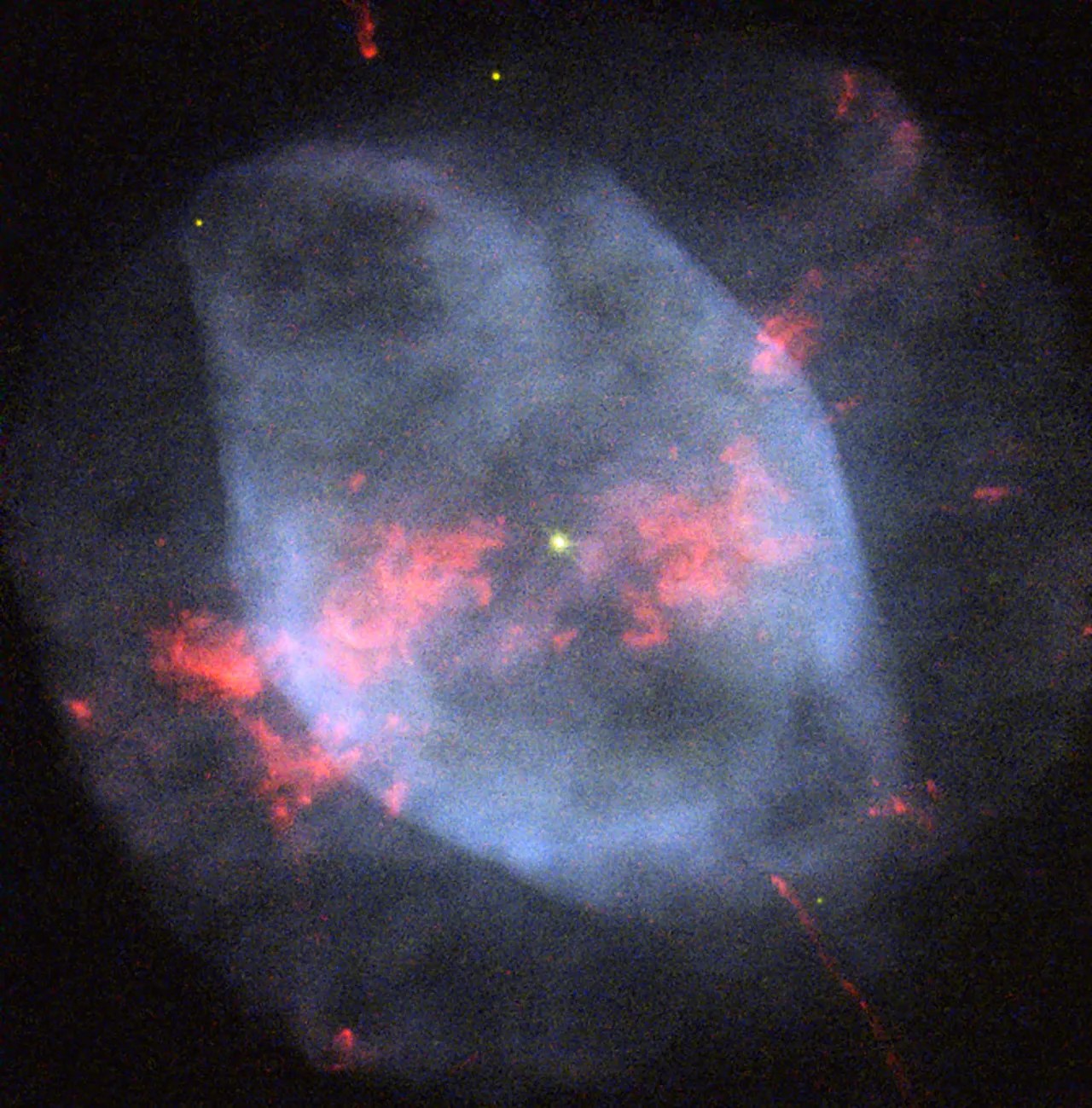 A smoky-blue double-shell of gas around an exploded star, splattered with pink