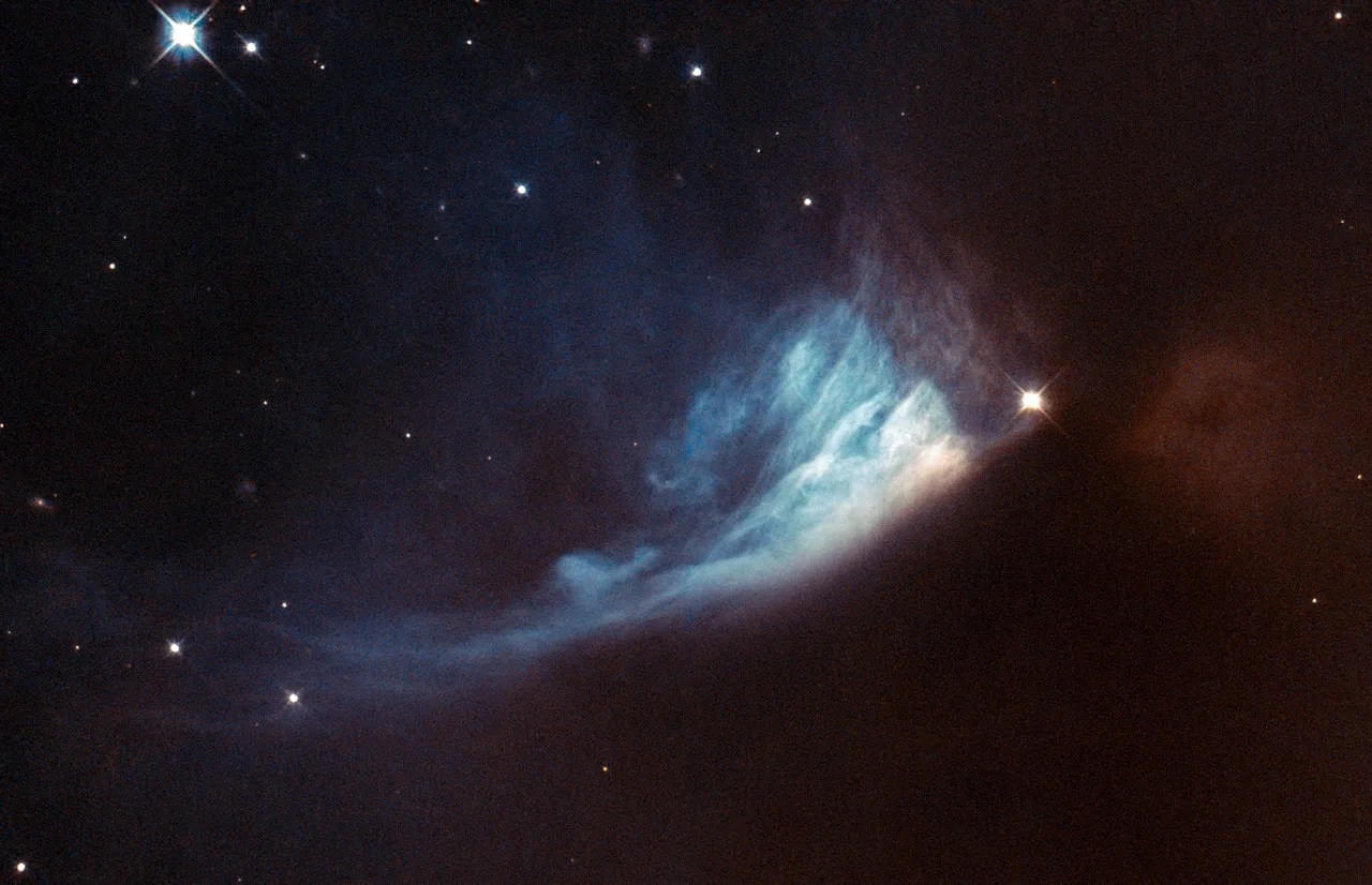 A bright star on the right appears to illuminate a swath of smoke trailing down and to the left