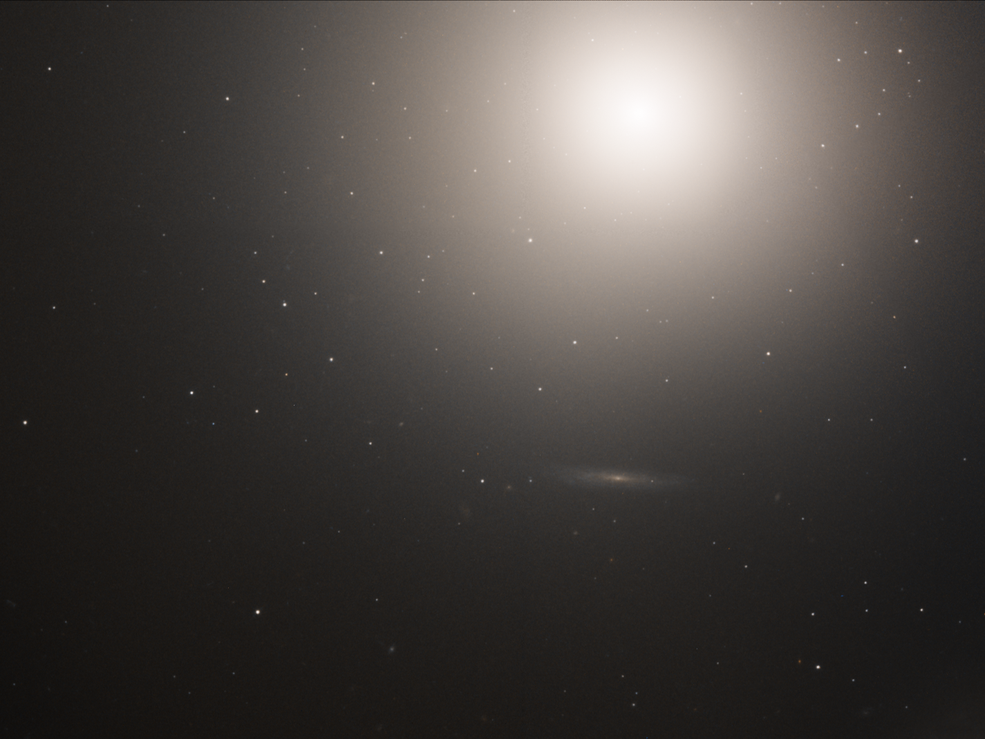 A hazy, yellow-white light shines near the top right, against black space dotted with faint, distant stars.