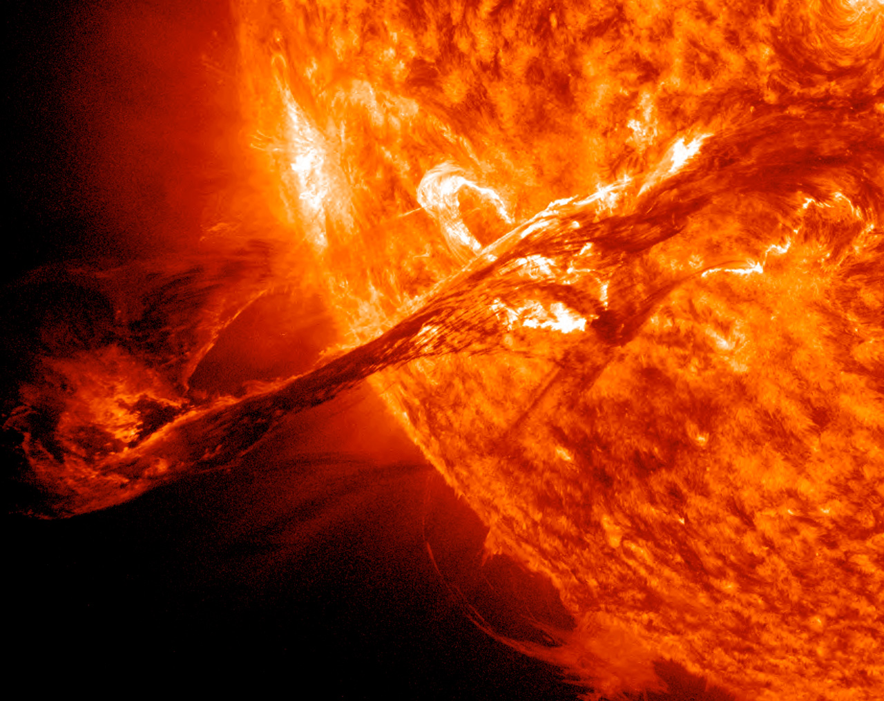 This close-up, detailed image of the Sun, captured by NASA's Solar Dynamics Observatory (SDO), shows a giant solar prominence erupting off of the Sun, like a giant loop of fire.