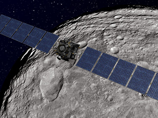 Artist's concept of the Dawn spacecraft soaring over the giant asteroid Vesta
