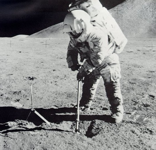 Photo of astronaut on the Moon digging into the surface.