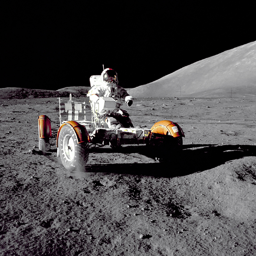 Photo of astronaut driving a vehicle on the surface of the Moon