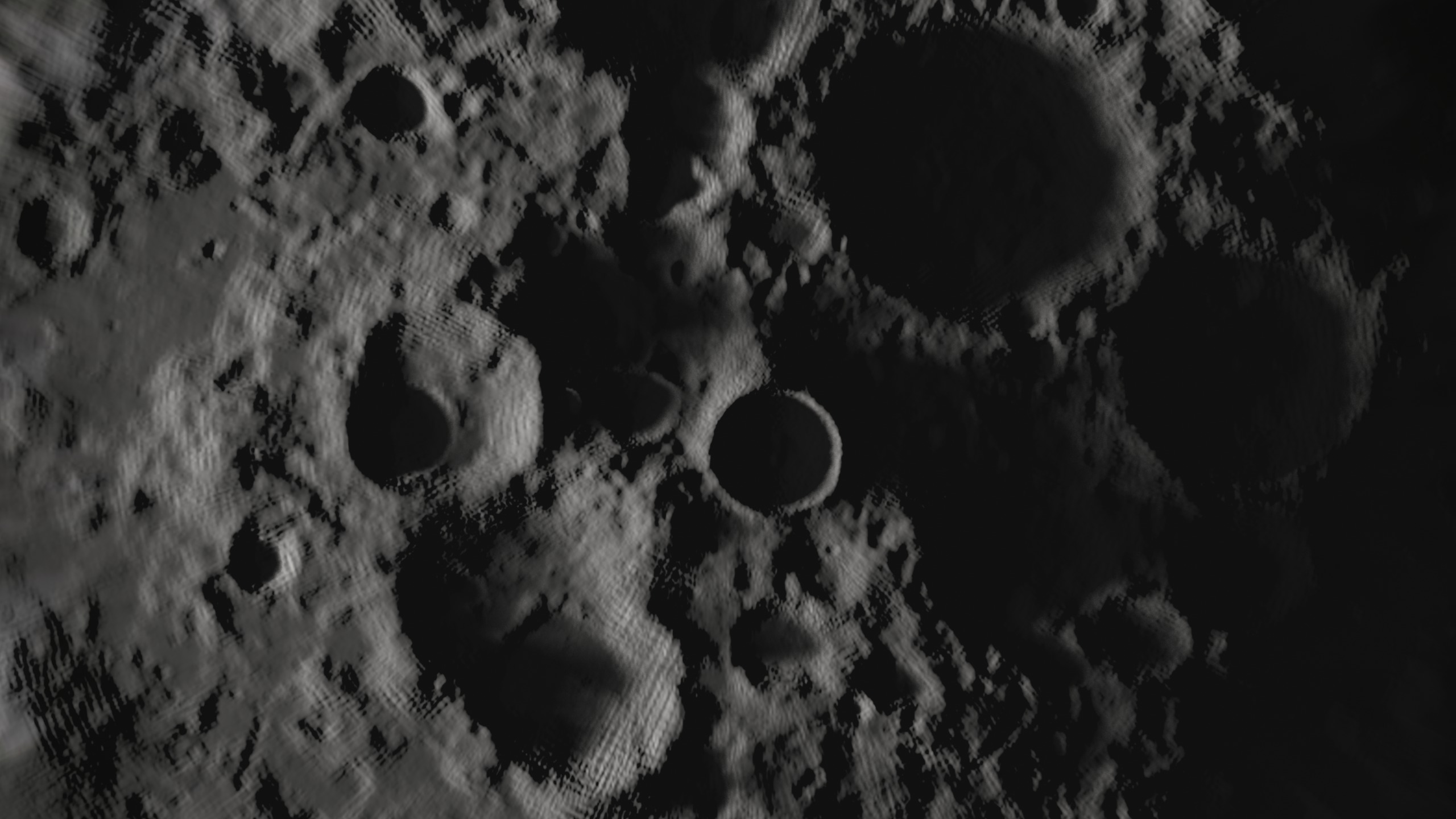 Photo of Moon's surface showing dark shadow in cratered regions